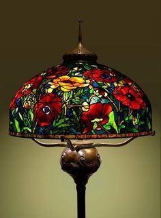 a lamp that is sitting on top of a table with a flower design on it