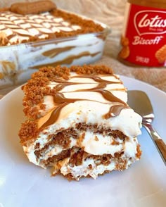 a piece of cake sitting on top of a white plate next to a container of ice cream