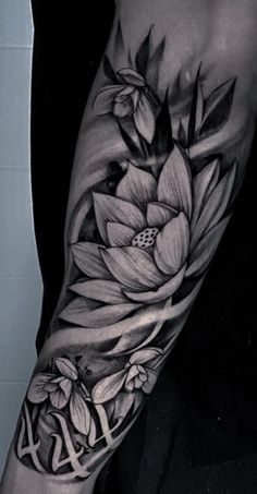 a black and white flower tattoo on the arm