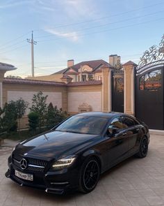 a black car parked in front of a house