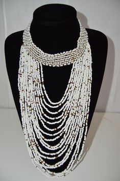 This Beaded African necklace is made with the finest quality beads that bring out mother earths most beautiful colors. It is traditionally worn by Kenyan women on special occasions such as weddings. Normal Fit. One size fits all. Perfect gift for that Special Person in your life. White Bohemian Beaded Necklace With Faceted Beads, White Beaded Necklace With Oval Beads, White Oval Beaded Chain Jewelry, White Bridal Necklace With Colorful Round Beads, Bridal Necklace With Colorful Round Beads In White, White Oval Beaded Necklace, Traditional White Beaded Bracelets With Faceted Beads, White Beaded Necklace With Colorful Beads For Weddings, White Beaded Necklaces With Colorful Beads For Weddings