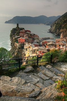 a scenic view of a village on the edge of a cliff