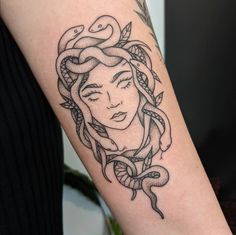 a woman with a snake tattoo on her arm