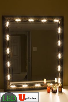 a lighted mirror sitting on top of a table