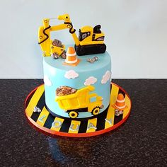 a birthday cake with construction vehicles on it