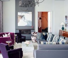 a living room filled with furniture and a chandelier