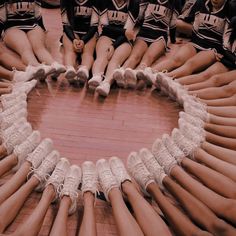 a group of cheerleaders sitting in the middle of a circle