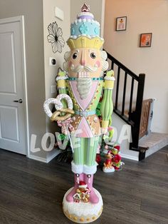 an elaborately decorated christmas tree in the corner of a room with wooden floors and stairs