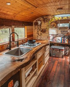 a kitchen area with sink, stove and oven