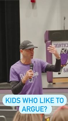 a man standing in front of a crowd holding a microphone