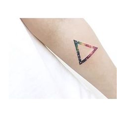 a woman's arm with a colorful triangle tattoo on the left side of her arm