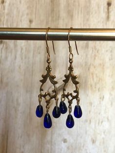 Bronze and blue dangle earrings.  Great for parties and/or elegant affairs. Elegant Blue Metal Clip-on Earrings, Elegant Blue Crystal Earrings, Blue Party Clip-on Earrings, Blue Dangle Crystal Earrings For Formal Occasions, Blue Crystal Drop Earrings For Formal Occasions, Blue Teardrop Jewelry For Evening, Elegant Blue Chandelier Earrings For Evening, Elegant Nickel-free Clip-on Earrings For Party, Elegant Blue Teardrop Earrings For Formal Occasions