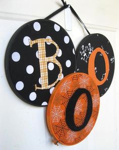 two black and white polka dot signs hanging on a wall with the letter b in it's center