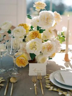 a table with flowers and place cards on it