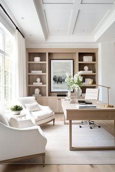 a living room filled with white furniture and lots of bookshelves on the wall