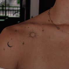 a man with a tattoo on his chest and the sun in the sky behind him