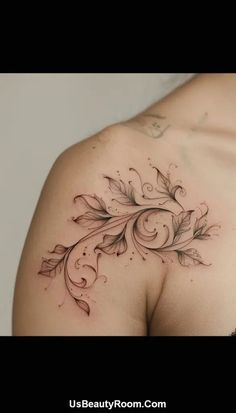 a woman's shoulder with leaves and swirls tattoo on it, in black and white