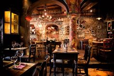 a dimly lit restaurant with tables and chairs