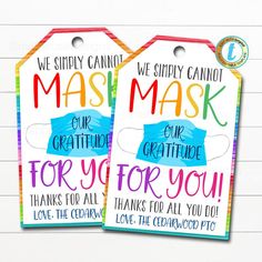 two colorful tags with the words, we simply cannot't mask our creativity for you