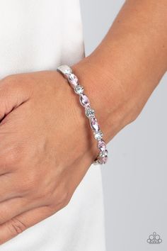 A sparkly collection of round white rhinestones and marquise pink rhinestones alternate across the top of the wrist, coalescing into a stackable bangle-like bracelet. Features a hinged closure.

Sold as one individual bracelet. Stackable Bangles, Hinged Bracelet, Sliding Knot, Paparazzi Accessories, White Rhinestone, Rhinestone Bracelet, Paparazzi Jewelry, Pink Rhinestones, Pink Bracelet