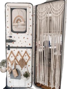 the inside of an open suitcase with macrame decorations