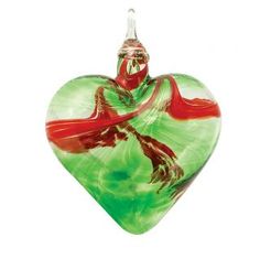 a heart shaped glass ornament with a red and green design