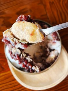 a spoonful of ice cream with cranberry topping