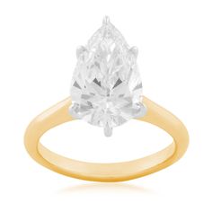 a yellow gold ring with a pear shaped diamond