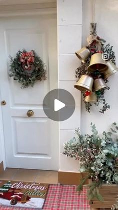 christmas wreaths and bells hang on the wall next to a white door with red checkered tablecloth