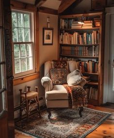 a living room filled with furniture and lots of books