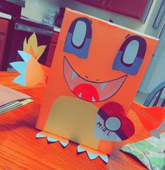 an origami monster sitting on top of a wooden table