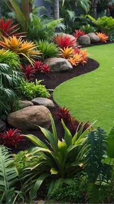 a lush green garden with rocks and flowers