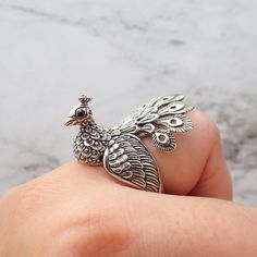 "Solid Sterling Silver Peacock Ring with Adjustable size. Stand out with this amazing statement ring! This gorgeous and unique ring is hand casted to catch each and every detail from the ornate feathers to each hair! His eyes are made of black crystal. This is a hearty ring, from our \"Wild Bay\" Collection. It is solid sterling silver and this ring will last for generations and generations. Despite its generous size it sits and wears very comfortably. Again this ring is SOLID silver NOT silver Luxury Peacock Design Jewelry For Festivals, Luxury Peacock Design Jewelry For Celebration, Luxury Fusion Jewelry With Peacock Design, Luxury Multicolor Peacock Design Jewelry, Luxury Fusion Style Jewelry With Peacock Design, Luxury Wedding Sets With Peacock Design, Luxury Peacock Design Jewelry For Anniversary, Luxury Peacock Design Jewelry For Diwali, Luxury Peacock Design Jewelry For Receptions