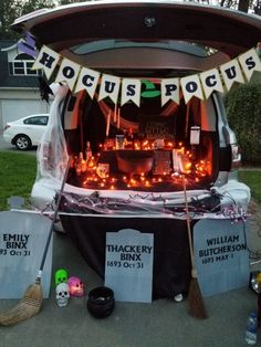 the trunk of a car decorated for halloween with decorations and lights on it's roof