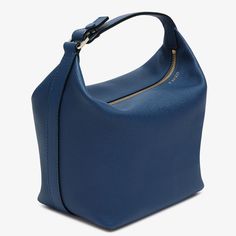 The Mochi bag is Valextra’s ode to contemporary elegance and material innovation. Crafted from our super soft Millepunte calf leather, it is a delight to hold and behold in this eye-catching sapphire blue hue. Inside this malleable everyday handbag there is space for everyday essentials that are kept secure by the easily gliding gold-tone zip fastening. Easily carried as a top-handle handbag or shoulder bag due to its extendable strap, it is appropriate for a myriad occasions. Finessed with our black lacquered Costa edging, its whispered credentials are cemented with its externally embossed foiled code that is unique to each handbag and the artisan who made it. Micro Bags, Blue Luxury, Everyday Handbag, Large Wallet, Backpack Travel Bag, Top Handle Handbags, Business Bag, Sapphire Blue, Small Accessories