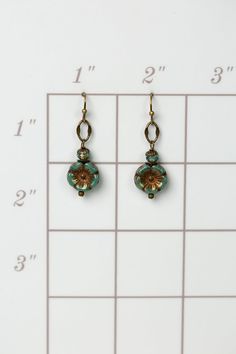 A symbol of peace and beauty, these handmade flower dangle earrings created with Czech glass and antique brass. Antique brass earwires (lead- and nickel-free) Czech glass Approximately 1.5" length Our unique handmade designer jewelry for women is made in America, each design created individually in our personal design studio in Floyd VA USA Bronze Czech Glass Jewelry With Ear Wire, Bronze Czech Glass Drop Earrings, Brass Flower Drop Earrings, Nickel Free Czech Glass Flower Earrings, Nickel-free Czech Glass Flower Earrings, Nickel-free Round Brass Flower Earrings, Gold Nickel-free Czech Glass Flower Earrings, Nickel-free Gold Czech Glass Flower Earrings, Nickel-free Gold Flower Earrings With Czech Glass