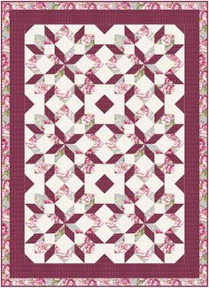 a pink and white quilt with flowers on it