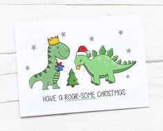 a christmas card with two dinosaurs wearing crowns