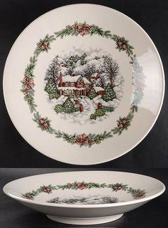 a white bowl with a christmas scene on the side and a red house in the middle