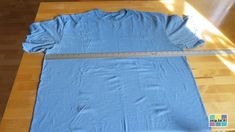 a blue t - shirt with a measuring tape on it