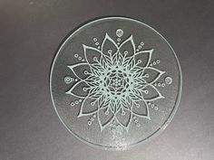 a glass plate with a flower design on it