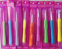 five different colored toothbrushes in plastic packaging