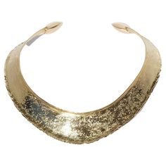 This 18 karat gold neck ring has a shiny, textured surface. The shape of the neck ring may be described as semi oval with an accentuated front. The neck ring's arms are equipped with square-shaped golden pillows on its ends. The neck ring looks like a piece of jewelry that could have been worn by an empress of the ancient Roman Empire. It radiates powerfulness and self-confidence and it is perfect for any social gathering. Do you know that Claës Giertta, in year 1969, designed the Swedish music Grammy Trophy, Golden Pillow, Ancient Roman Empire, Neck Rings, Neck Ring, Social Gathering, Roman Empire, Music Industry, Choker Necklace