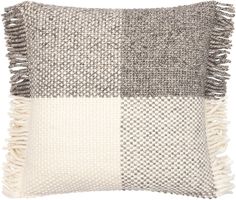 a gray and white pillow with fringes on the front, two different color squares