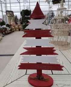 a small wooden christmas tree sitting on top of a table