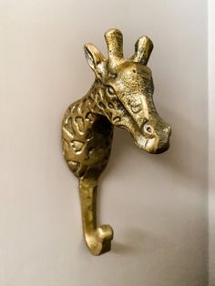 a gold giraffe head mounted on a wall