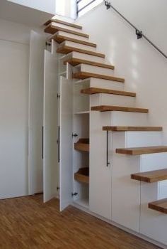 the stairs are made of wood and white