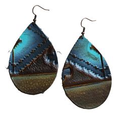 Genuine Leather Teardrop Earring is the perfect complement to your boho or western style. Please note, We only use real leather hides. As a result, due to natural variations, no two pairs of earrings will be identical. Length: 2.75" Width: 1.75". Although your item will resemble the photo, each piece is created by hand, so no two are identical. Brown Bohemian Concho Earrings, Rustic Handmade Teardrop Earrings, Bohemian Hand-tooled Leather Earrings, Handmade Brown Bohemian Teardrop Earrings, Brown Hand Tooled Earrings For Festival, Hand-tooled Brown Earrings For Festival, Bohemian Brown Teardrop Nickel-free Earrings, Blue Bohemian Leather Earrings, Nickel-free Bohemian Brown Teardrop Earrings