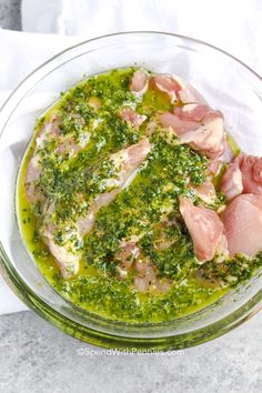 a glass bowl filled with meat and pesto