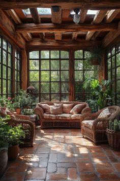 the sun shines through large windows into an outdoor room with wicker furniture and potted plants